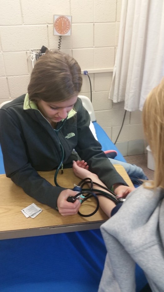 Nurse taking person's blood pressure