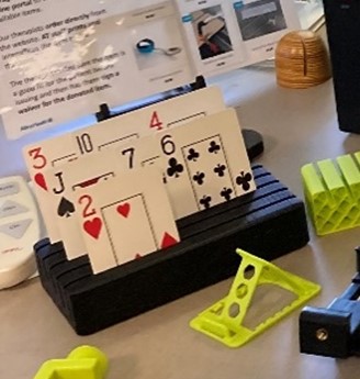 A blue piece of plastic holding seven playing cards.