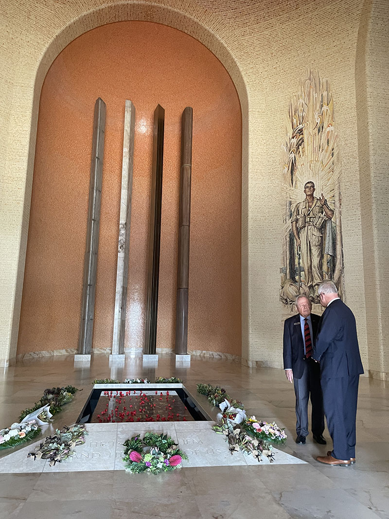 Governor Walz stands with an older man at a war memorial