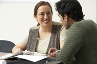 Woman smiling at man over some papers