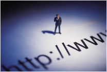 Small figure of person standing above a web address