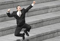 Businessman jumping with joy